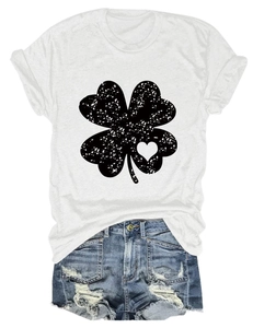 Flat lay of women's white crew neck T-shirt with four-leaf clover heart print and denim shorts