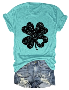 Flat lay detail of mint green clover t-shirt with vintage heart pattern and denim shorts