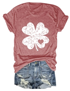 Close-up of brick red clover t-shirt with heart detail and distressed denim shorts