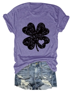 Flat lay of purple clover t-shirt with heart cutout and distressed denim shorts