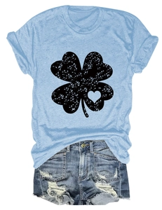 Detail of light blue t-shirt with four-leaf clover print and distressed denim shorts set