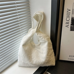 White canvas tote bag with delicate floral embroidery for daily commute and casual style