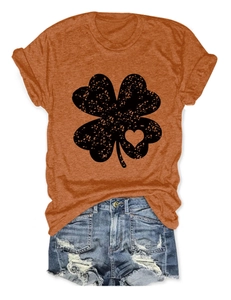 Detail view of cotton t-shirt clover heart print and distressed denim shorts texture