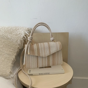 Chic woven straw crossbody bag with colorful striped flap and metallic hardware