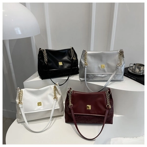 Fashionable tote bags in black, silver, white, and burgundy colors with gold hardware