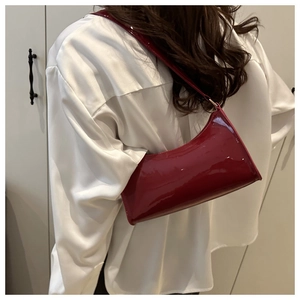 French style red patent leather baguette bag shown as a chic underarm shoulder accessory