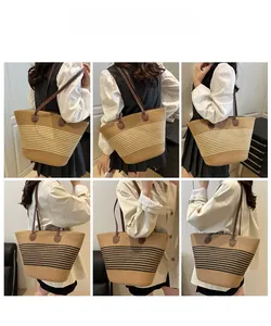 Detail showing large capacity woven straw tote bag with stripes and brown PU handles