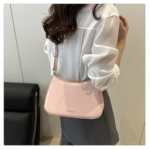 Fashionable pink matte leather underarm bag with zipper closure shown on model