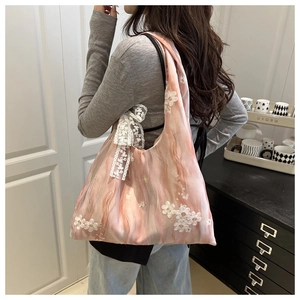 Detailed shot of pink chiffon tote bag with 3D lace flowers and bow, showing large capacity