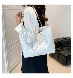 Detail of white striped embroidered tote bag showing colorful wave patterns on model