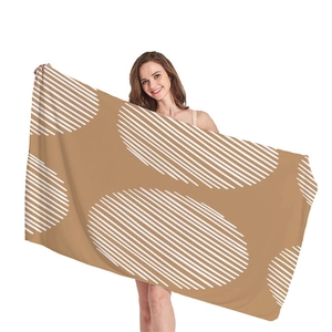 Thick beach towel with geometric circle patterns on a tan background for vacation