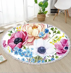 Close-up of circular floral beach towel with tassels on a light wooden floor scene