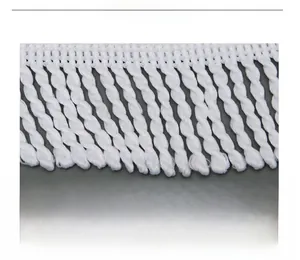 Detail of white twisted fringe trim and tassel braiding on a round beach towel
