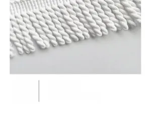 Close-up of white twisted rope fringe tassels on floral round beach towel edge
