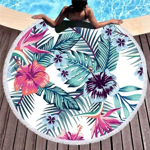 Thick round tropical beach towel with pink hibiscus flowers and white fringe tassels