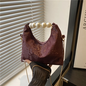 Deep red crocodile texture handbag with pearl top handle and gold chain shoulder strap
