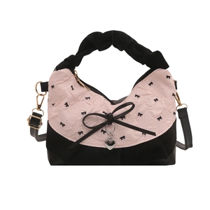 Pink and black pleated handbag with bow prints, large bow detail, and a heart pendant