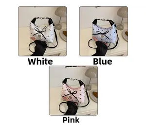 Close-up of quilted floral crossbody bags with bow details in white, blue, and pink