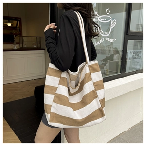 Detail of striped canvas tote bag with thick fabric texture and spacious design