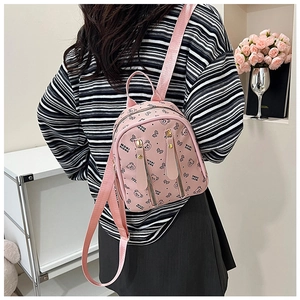 Detail view of pink mini backpack with cute bear print and decorative vertical zippers