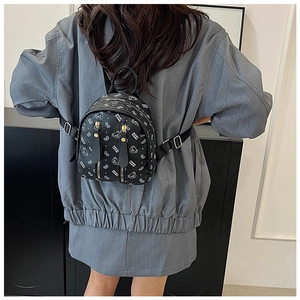 Detail of black mini backpack with cartoon bear prints and adjustable shoulder straps