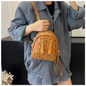 Detail of caramel mini backpack with cartoon bear pattern and dual vertical zippers