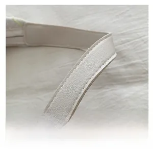 Detail shot of beige PU leather strap with premium stitching on large casual tote bag