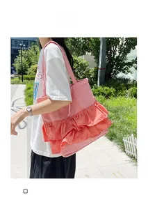 Detailed view of pink pleated tote bag with tiered ruffles and shoulder strap design