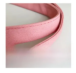 Close-up of durable reinforced pink canvas handles with premium stitching details
