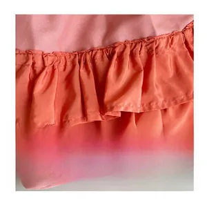 Detail of pink canvas and orange chiffon pleated ruffles on a large casual tote bag