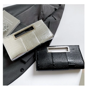 Detailed macro of crocodile pattern clutches with stylish silver metal frame handles