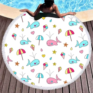 Round cartoon mermaid beach towel with white tassels on a wooden pool deck