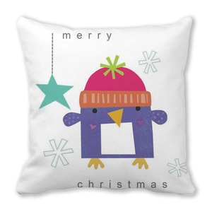 Detail of white square pillow cover with purple cartoon penguin and Merry Christmas print