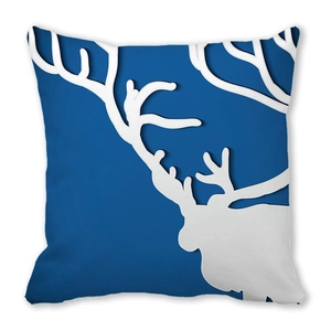 Close-up of a square cushion cover with a white reindeer head print on navy blue fabric