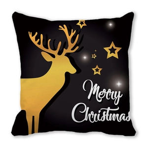Close-up of black Christmas pillow case with golden elk, stars and Merry Christmas text
