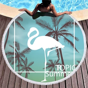 Thick round tropical beach towel with flamingo palm design and white fringe tassels