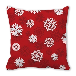 Close-up of red Christmas pillow case with detailed white snowflake pattern prints