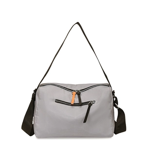 Minimalist grey nylon crossbody bag with black strap and bright orange zipper detail