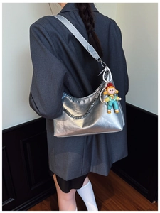 Silver metallic hobo bag with chain strap and colorful clown doll charm detail