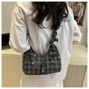 Grey plaid shoulder bag with bow details and silver beads shown on model
