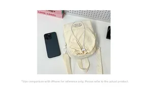 Beige drawstring crossbody bag shown next to an iPhone for precise size comparison