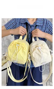 Fashionable nylon drawstring crossbody bags in lemon yellow and cream white colors