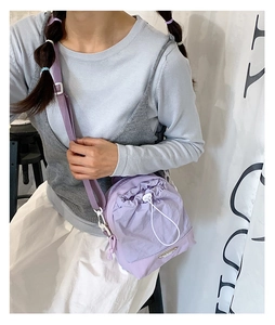 Detail of light purple drawstring crossbody bag with adjustable nylon shoulder strap
