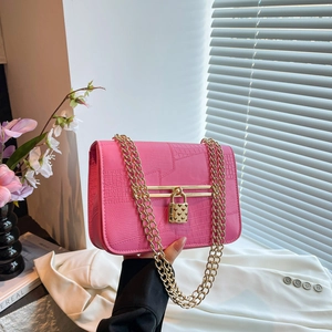 Bright magenta crocodile embossed crossbody bag with golden heart lock and chain strap
