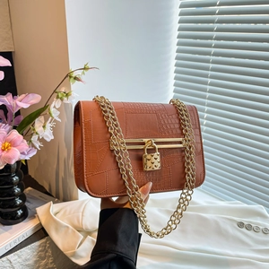 Brown alligator pattern leather crossbody bag with gold chain and heart lock detail