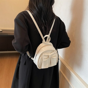 Minimalist cream white mini backpack for women featuring a stylish oversized decorative bow