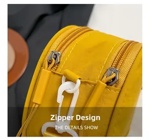 Detail of yellow Oxford cloth bag showing smooth double zipper design and white hook