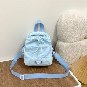 Light blue nylon drawstring crossbody bag with adjustable strap and fashion patch logo