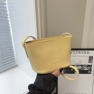 Fashionable yellow lychee pattern bucket bag with adjustable shoulder strap for women