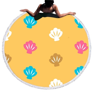 Round beach towel with yellow shell print and white fringe tassels for picnic or beach